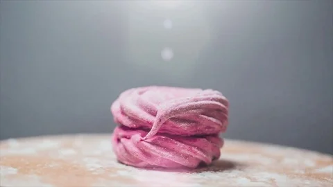 Spinning red marshmallow in the studio. Isolated marshmallow. Video stock 73503317