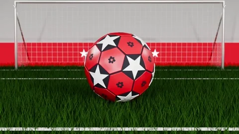 Spinning red soccer ball rolling forward after pullback, settling on green pitch Video stock 333286119