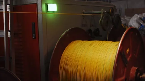 Spinning reel with yellow cable in cable production close-up Stock Footage 162598213