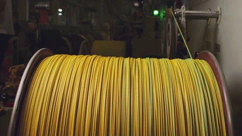 Spinning reel with yellow cable in cable production close-up Stock Footage 162598716