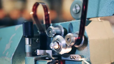 Spinning reels of the functioning film projector in a close up Stock Footage 147238186