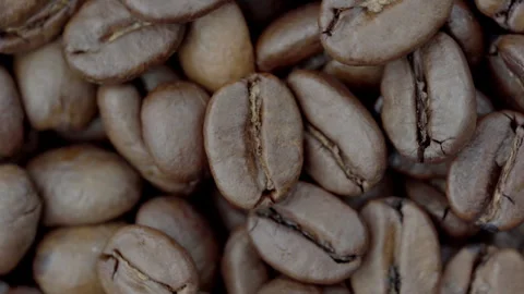 Spinning Roasted Coffee Beans Macro Close-Up Video stock 329450607