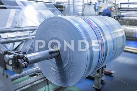 Spinning Roll Of Printed Packaging In Food Packaging Printing Factory