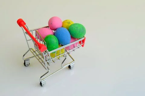 Spinning shopping trolley with Easter eggs Stock Photos