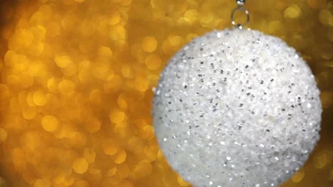 Spinning silver Christmas ball on bokeh background Stock Footage 256090167