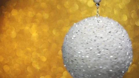 Spinning silver Christmas ball on bokeh background Stock Footage 256090201