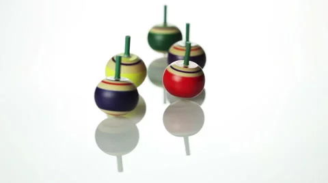 Spinning spin tops on white surface Stock-Footage 41950016