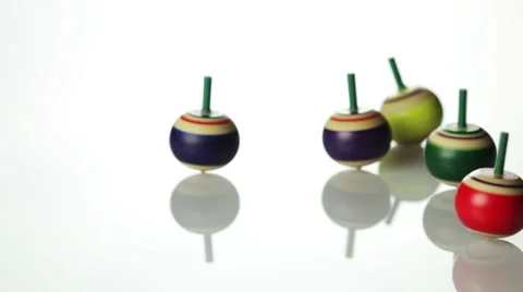 Spinning spin tops on white surface Stock Footage 41950194