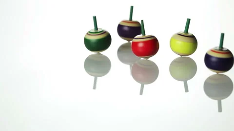 Spinning spin tops on white surface Stock-Footage 41950304