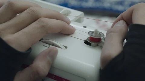 Spinning of spool with red thread on embroidery machine Stock Footage 89330380