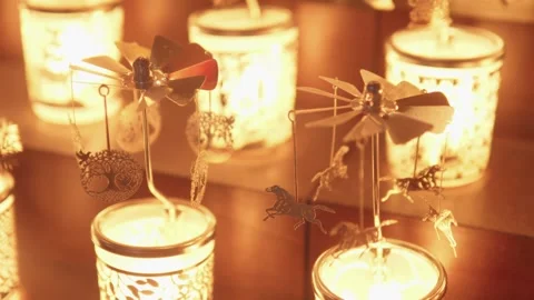 Spinning Tea Light Carousel Over Candles With Metal Petals Rotating Above Vídeo Stock 327583815
