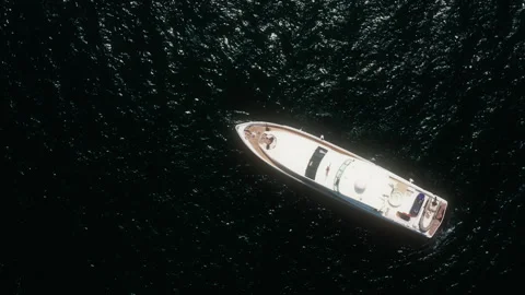Spinning top down drone rising above luxury yacht in Dubai Video stock 345097346