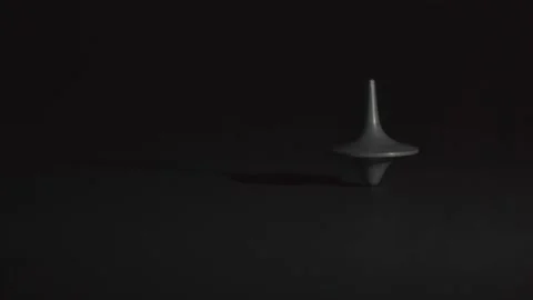 Spinning top in motion without falling against black background, in black Stock Footage 133046862