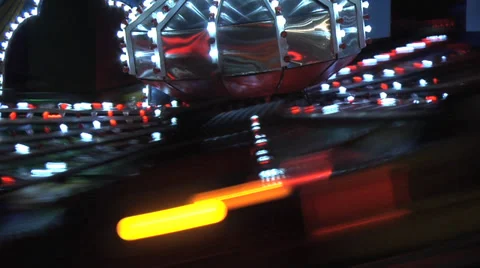 Spinning train fair ground ride, nightime, slo motion, slo shutter. Static MS Stock Footage 27631753