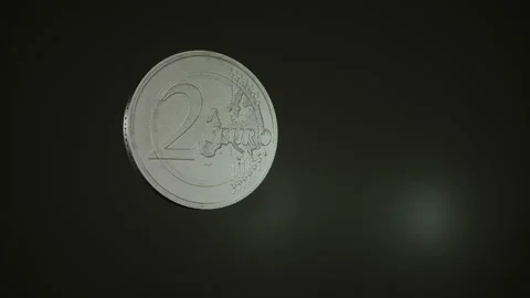 Spinning two euro coin in slow motion Stock Footage 157750177
