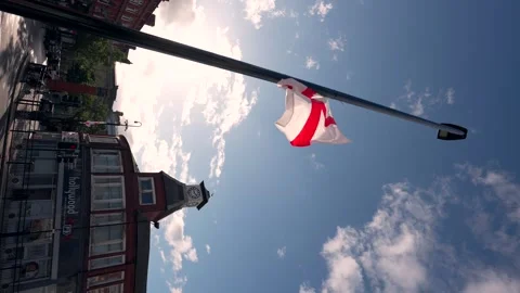 Spinning view of a St Georges flag on a lamppost in a northern English town Stock Footage 317234324