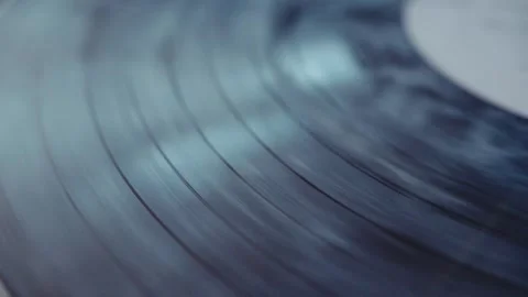 Spinning vinyl record creating a captivating visual effect on a turntable Video stock 293698352