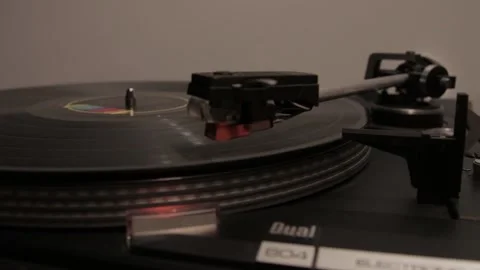 Spinning vinyl record creating a nostalgic ambiance on a classic turntable Stock Footage 289473239