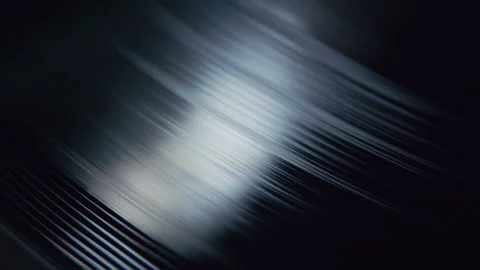 Spinning Vinyl Record Grooves with Light Reflection Stock Footage 345397742