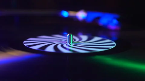 Spinning Vinyl Record on Turntable and Colorful Lights, Close Up Stock Footage 342737701