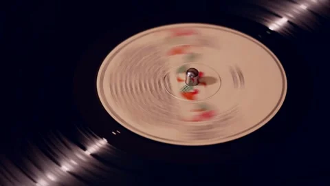 A spinning vinyl record on a turntable captured with a slow shutter speed Stock Footage 310050972