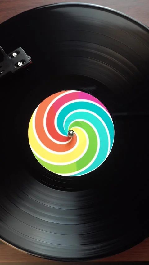 Spinning Vinyl Record on Turntable, Vertical View of Rainbow Optical Illusion Stock Footage 337564748