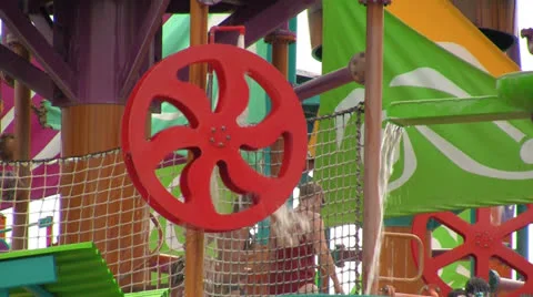Spinning Water Wheel wit People at Kids Water Park Play Area Stock Footage 24686032