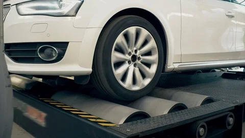 Spinning wheels automobile standing at rollers for measuring car power Stock Footage 81227985