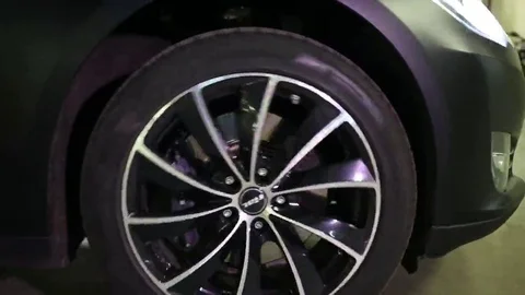 Spinning wheels of going Tesla S car in ... | Stock Video | Pond5