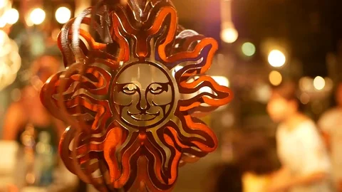 Spinning wind ornament in the shape of the sun at a night market in Wakiki in Ha Stock Footage 88630418