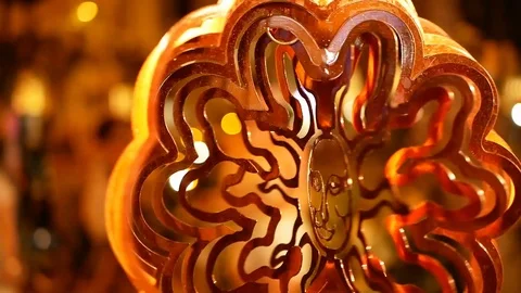 Spinning wind ornament in the shape of the sun at a night market in Wakiki in Ha Stock Footage 88630423