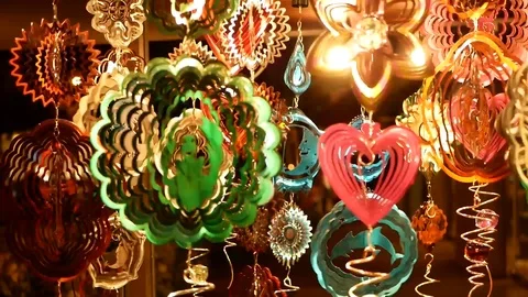 Spinning wind ornaments in various shapes and colors at night in Wakiki in Hawai Stock Footage 88630426
