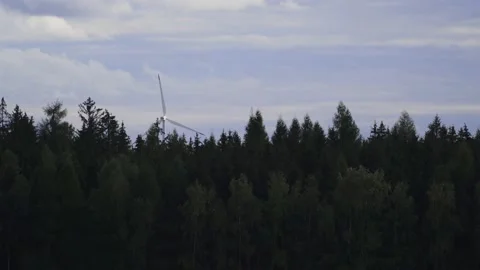 Spinning windmill behind a forest Stock Footage 140654448