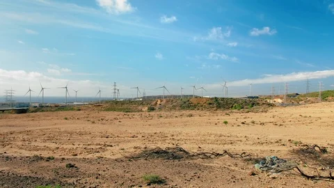 Spinning windmills to generate electricity, rolling hills an alien landscape Stock Footage 121086140