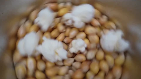 Spinning Yellow Popcorn Seeds Exploding And Flying Up in slow motion,close Stock Footage 155426376