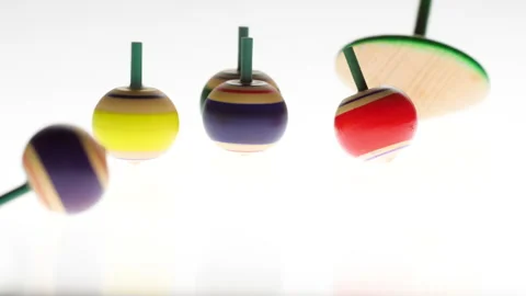Spintops spinning on white background Stock-Footage 138874798
