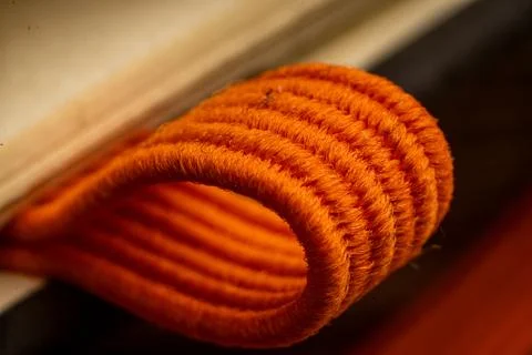 Spiral binding detail of a notebook with emphasis on vibrant orange loop in an Stock Photos