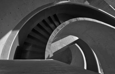 Spiral Concrete Staircase With Dramatic Shadows and Curved Architectural Stock Photos