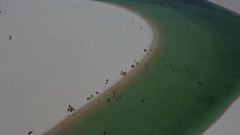 Spiral drone pull-out over turquoise lagoon in Lençóis Maranhenses, Brazil Video stock 328190196
