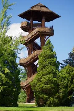Spiral Lookout Tower with Blue Sky, Green Trees, and white clouds Stock Photos