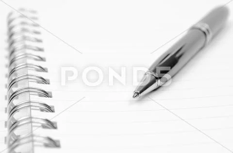 Spiral notebook and pen Stock Photos