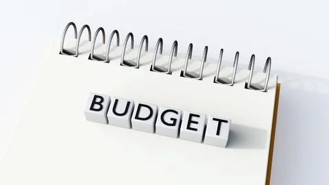 A spiral notebook and white blocks  spell out the word "BUDGET". Ilustração Stock