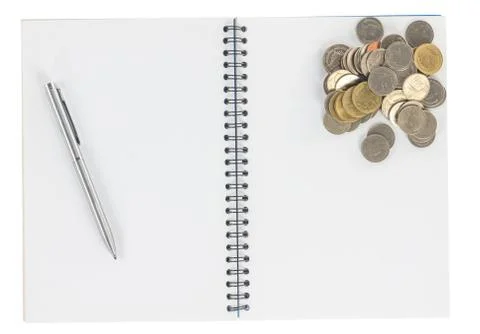 Spiral notebook with coins isolate Stock Photos