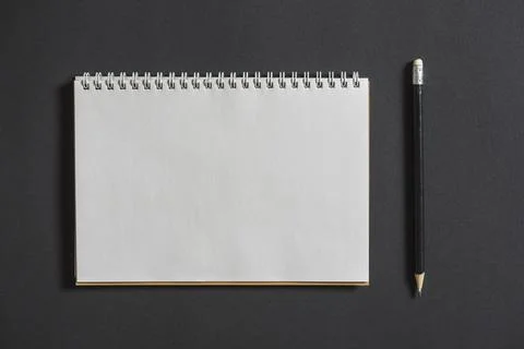 Spiral notebook with pencil grey background Stock Photos