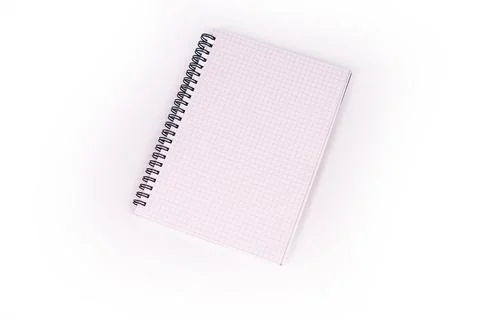 Spiral notebook with pink grid pages diagonally placed, providing a subtle te Stock Photos