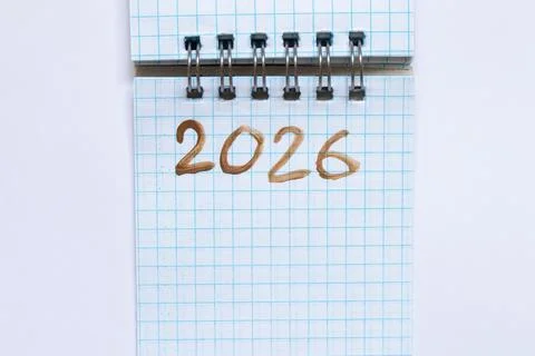 Spiral notebook with squared text 2026 written in brown paint as a concept of Stock Photos