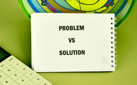 Spiral notebook titled PROBLEM VS SOLUTION on a green surface with a white Stock Photos