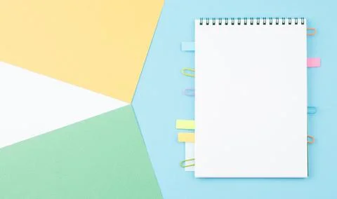 Spiral notepad on color background. Stock Photos