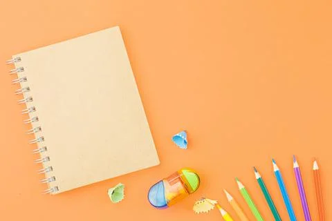 Spiral notepad with colored pencils. Stock Photos