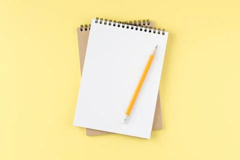 Spiral notepad on yellow background Foto stock